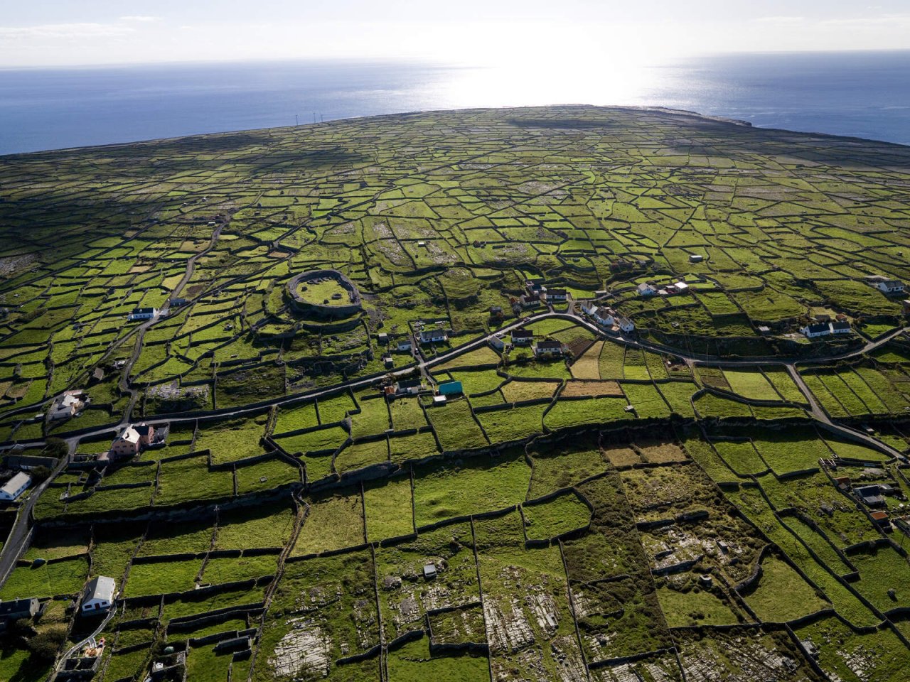 The patchwork fields of the middle Aran Island, and Dún Chonchuir or Conor's Fort which is a popular attraction on Inis Meáin