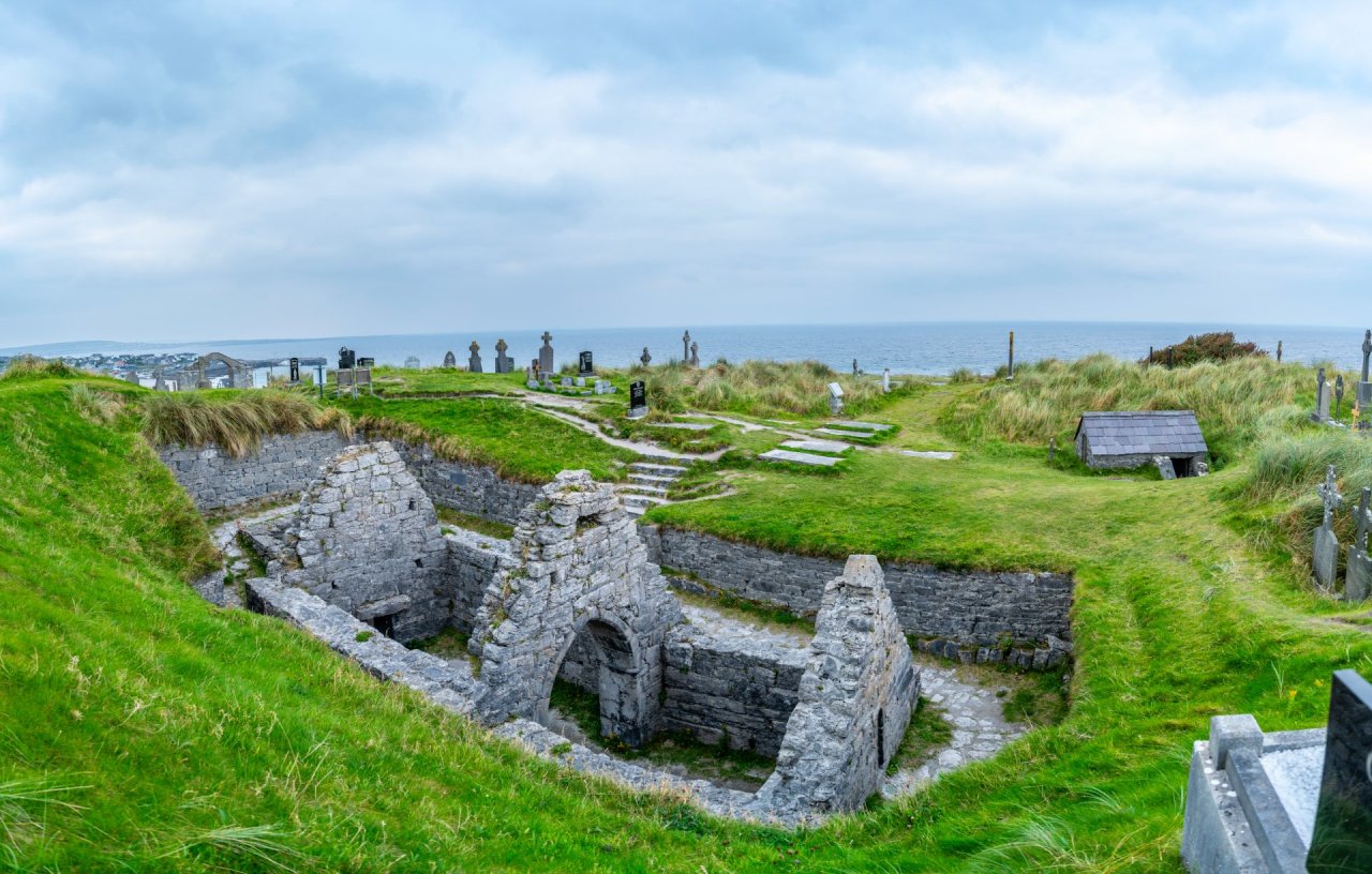 Ancient Cemetery and the sunken church ruins among lush green fields